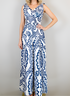 Woman wearing a blue and white patterned dress against a plain background